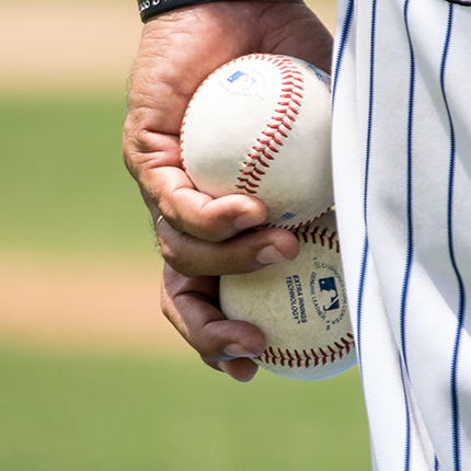 player holding baseballs