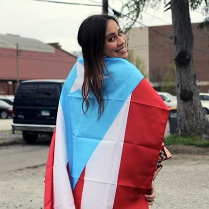 Headshot of Ana Isabel González with the Puerto Rican flag