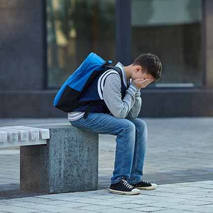 Boy crying outside school