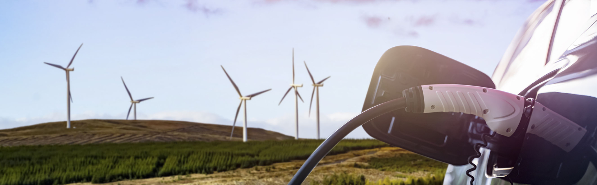 Stock image of electric vehicle and wind farm